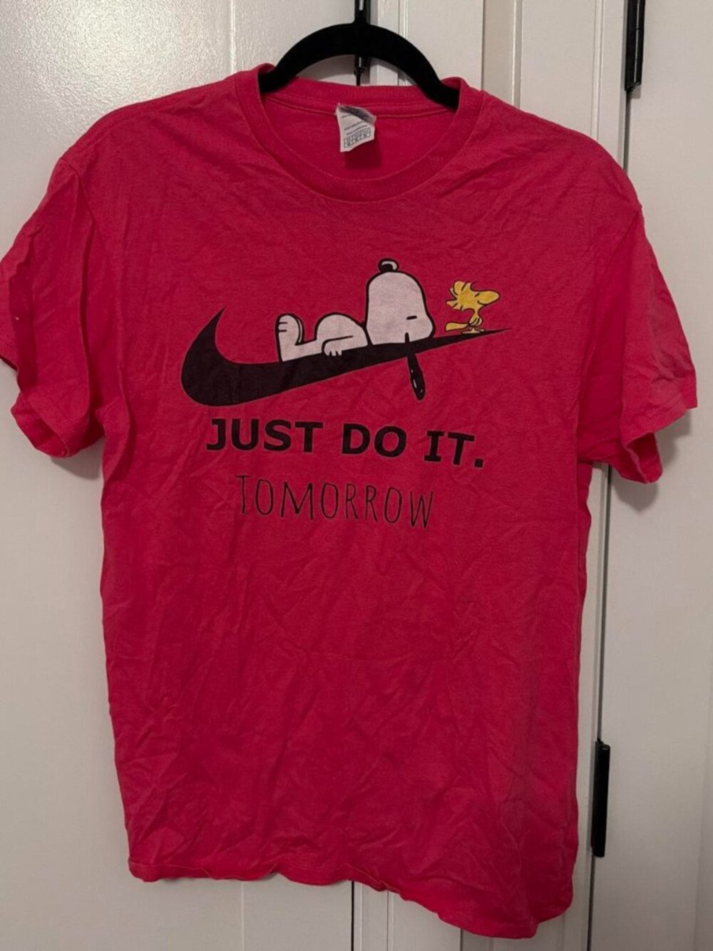 Red Nike x Snoopy tee with black swoosh graphic